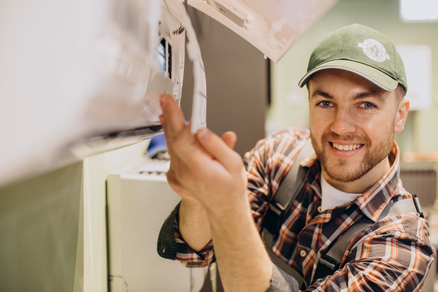 Keen technician servicing an air conditioning unit