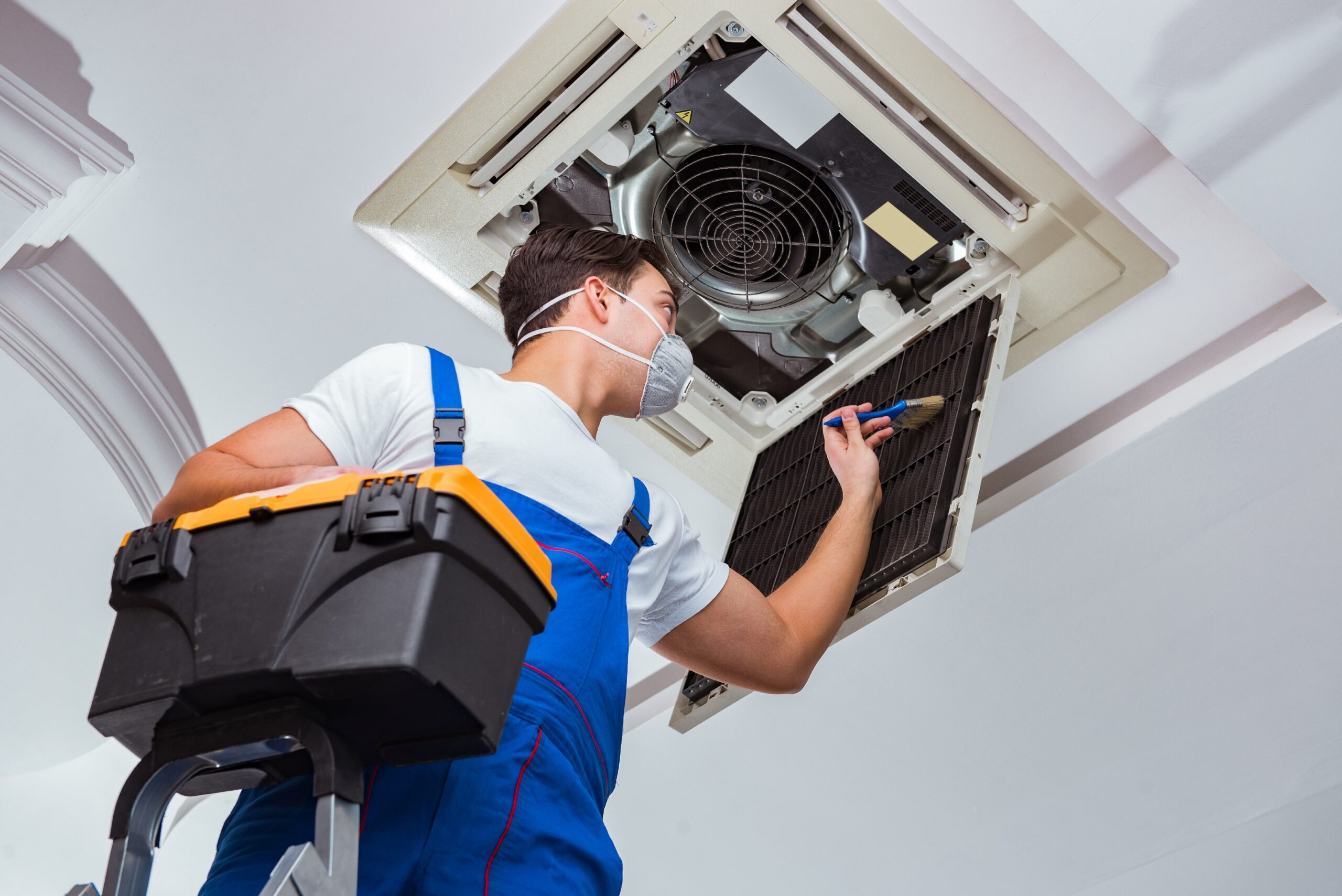 Keen technician repairing an air conditioning unit